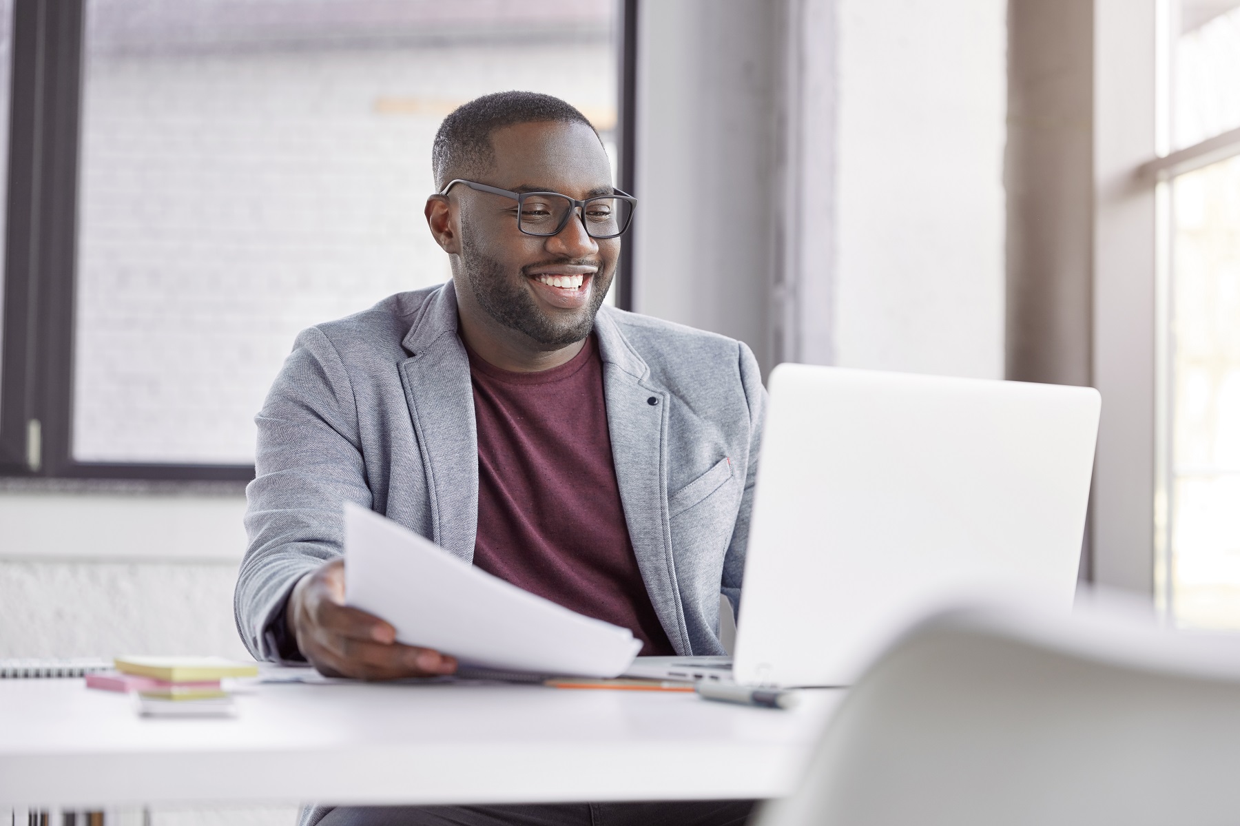 Man smiling while using laptop