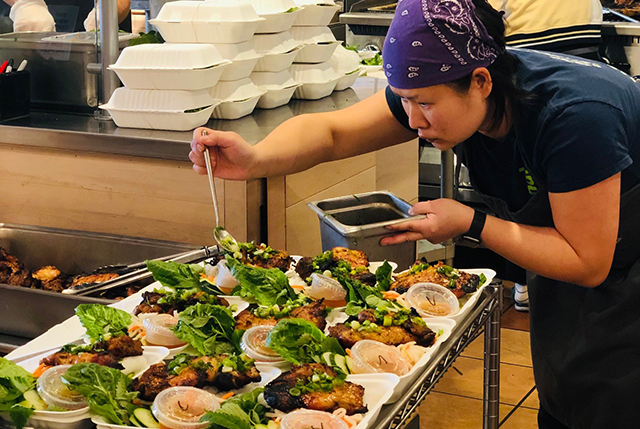 Tran Lee, owner of Viet Citon, prepares meals in the restaurant kitchen