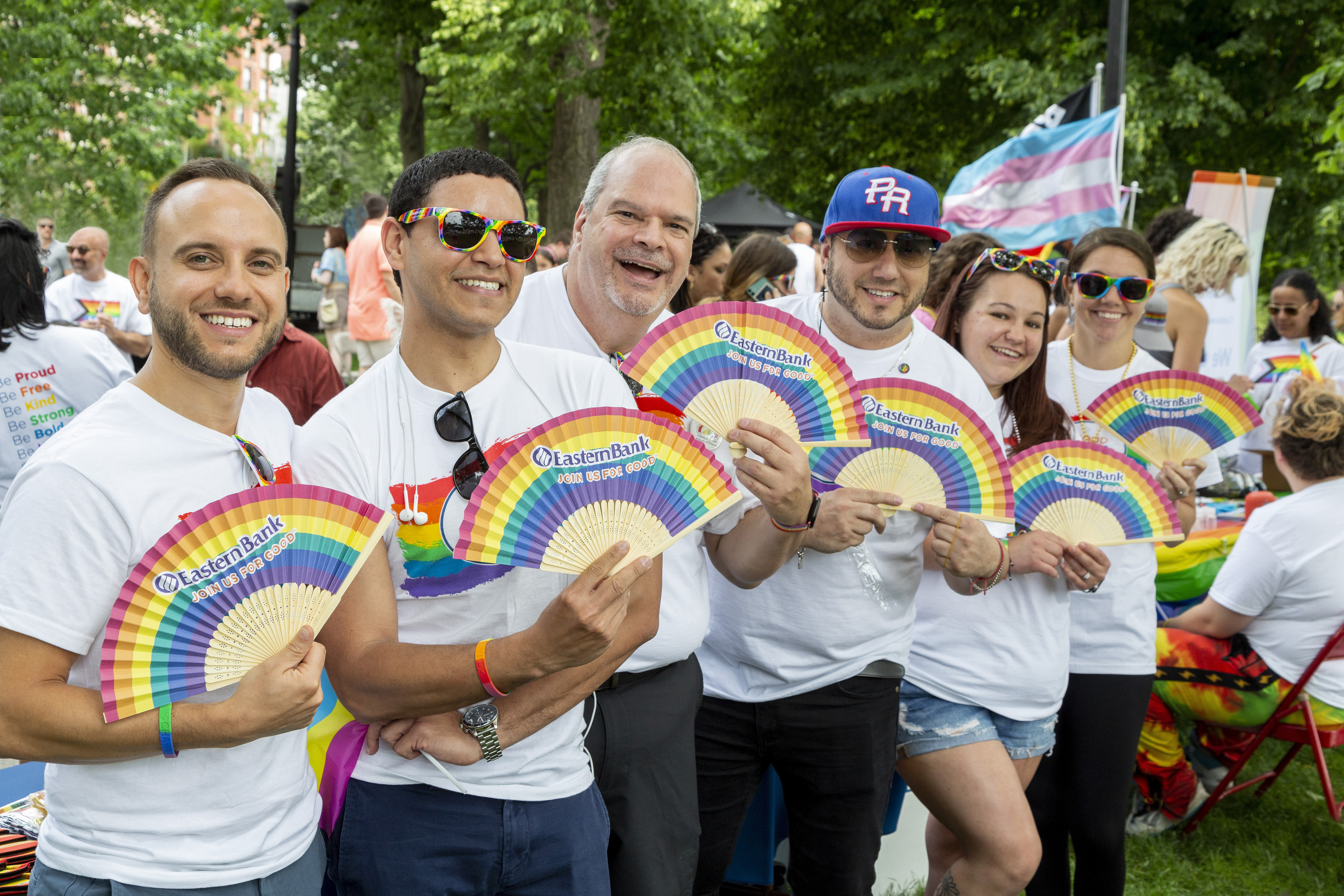Six people show off their rainbow paper fans for pride