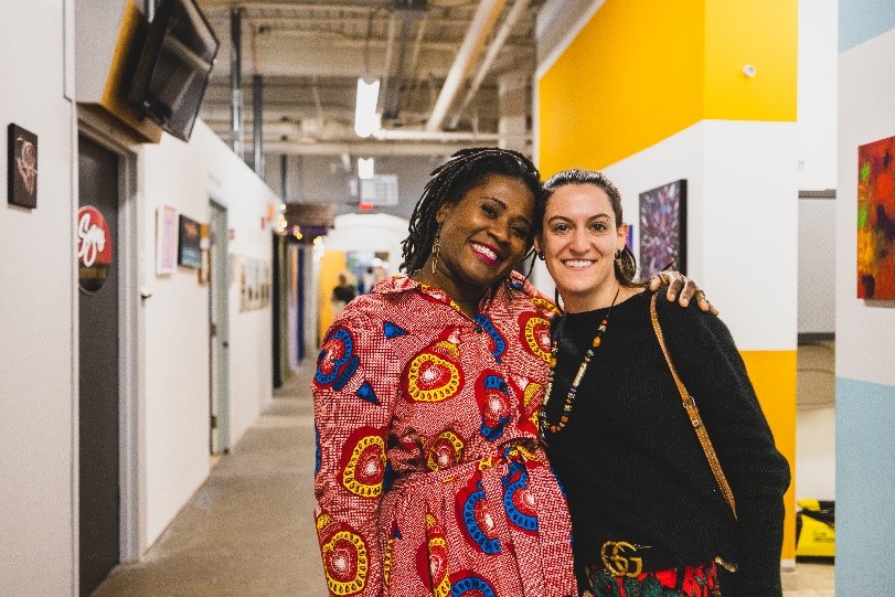 Two women pose together inside of the Western Ave Studio and Lofts