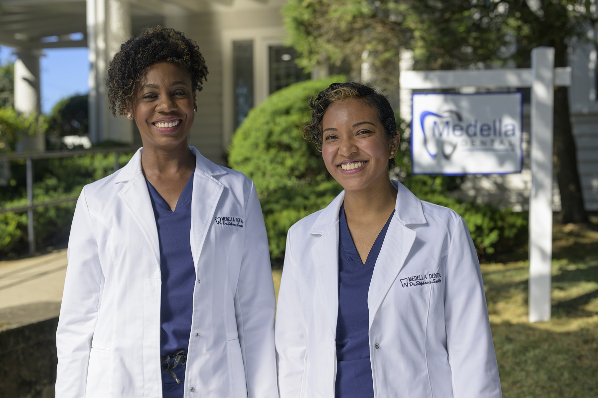 Dr. Sabrina Coombs and Dr. Stephanie Sadler of Medella Dental stand in front of their office