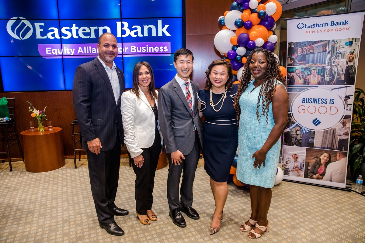 Eastern Bank President Quincy Miller stands with four fireside chat participants