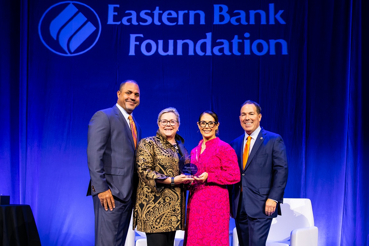 Vanessa stands with Eastern Bank to receive her award