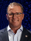 Brendan O'Neill wears glasses, has short cropped hair, and smiles for the camera