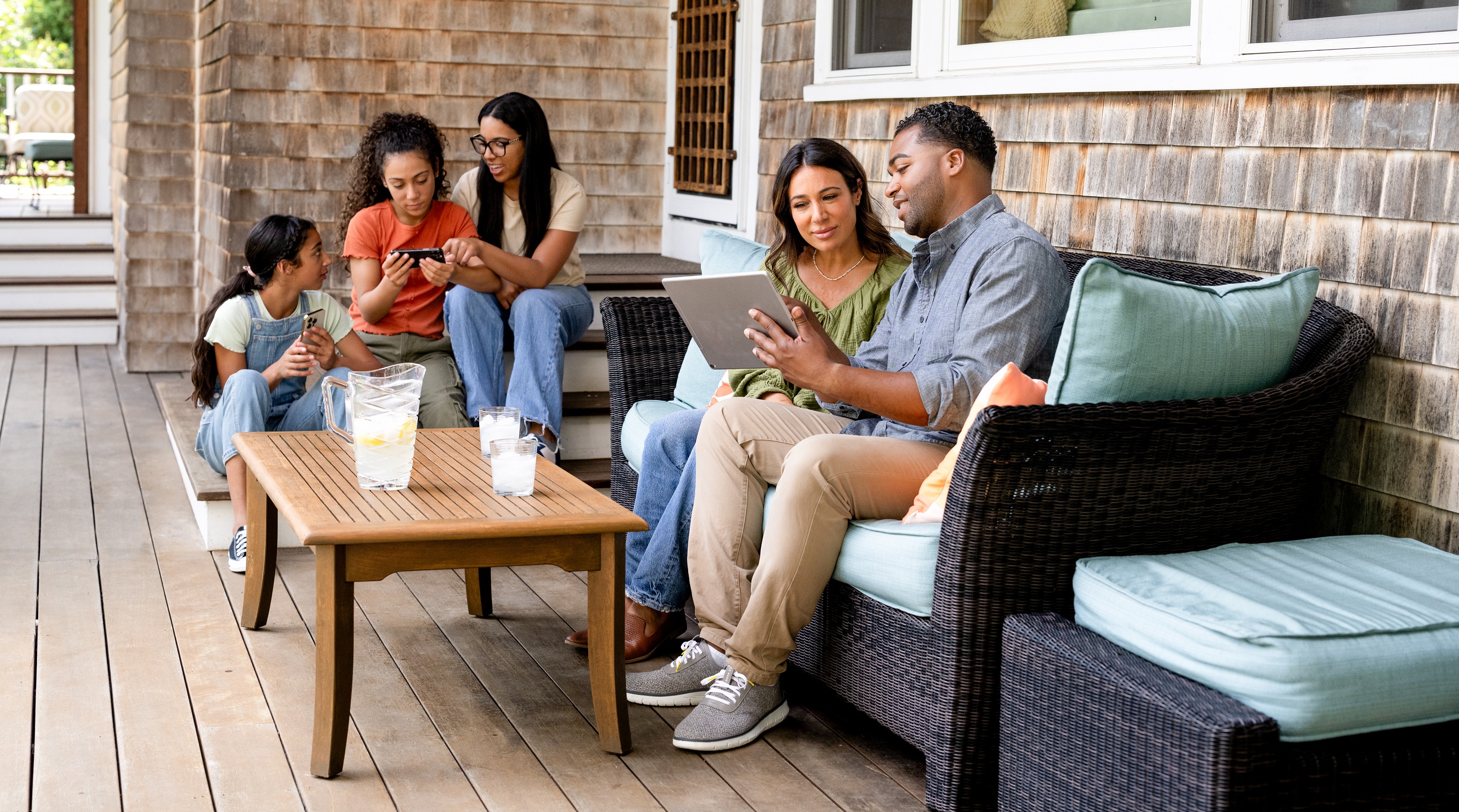 A family sits outside on their new patio together
