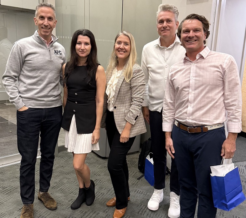 Ashley Eknaian stands with fellow speakers at the Boston Fintech Conference