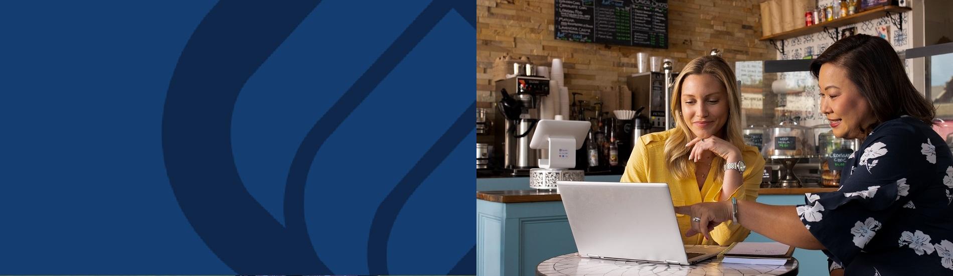 An image of an Eastern Bank banker meeting with a customer in her coffee shop