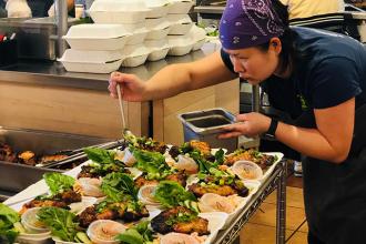 Tran Lee, owner of Viet Citon, prepares meals in the restaurant kitchen
