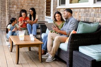 A family sits outside on their new patio together