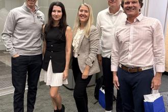 Ashley Eknaian stands with fellow speakers at the Boston Fintech Conference