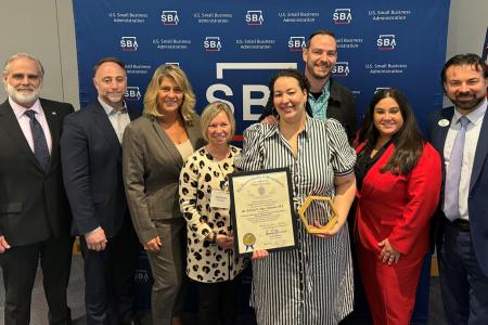 Eastern's Business Banking team stands with the EmVision team as they hold their award for small business of the year