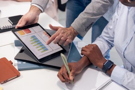 Analysts review data on a tablet together