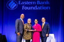 Vanessa stands with Eastern Bank to receive her award