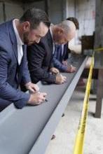 Members sign a steel beam