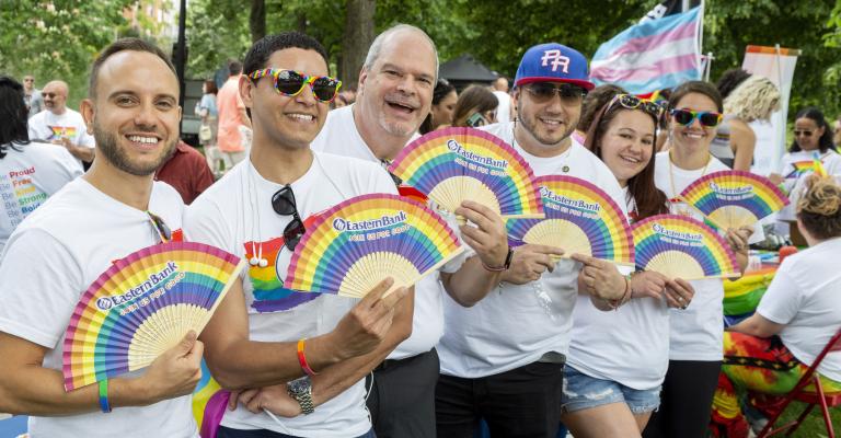 Six people show off their rainbow paper fans for pride