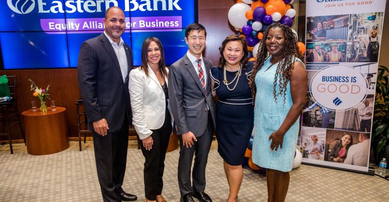 Eastern Bank President Quincy Miller stands with four fireside chat participants