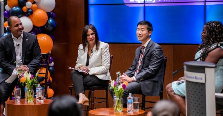 Speakers sit before an audience and discuss Equity Alliance for Business
