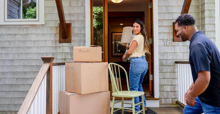 A family moves boxes into their new home