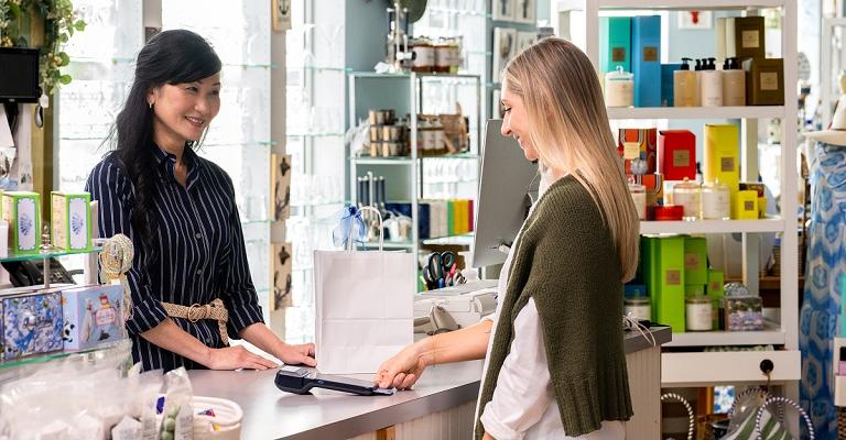 A woman makes a purchase using her credit card