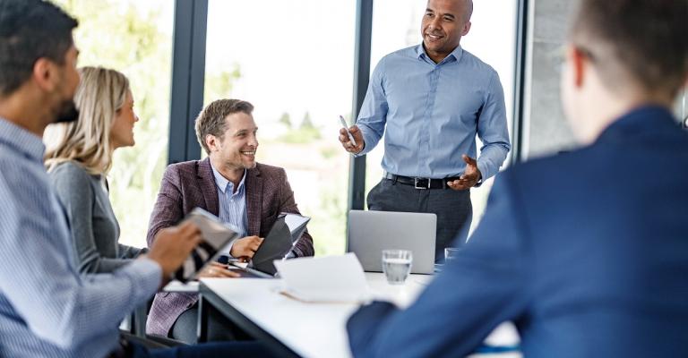 Board members are happy to meet together around an office table